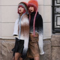 Twins Ami & Aya Amiaya were seen wearing black boots, a black and brown skirt, colorful hats and white and brown as well as white and black striped...