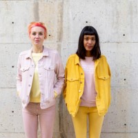 two alternative friends having fun, wearing yellow and pink jeans clothes - fashion stock pictures, royalty-free photos & images