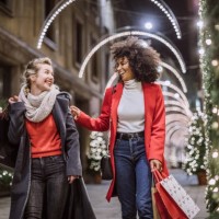 two attractive young women in christmas shopping - fashion stock pictures, royalty-free photos & images