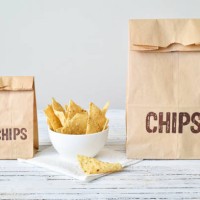 two bags of nacho chips in different sizes - junk food stock pictures, royalty-free photos & images