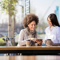 two beautiful females drinking coffee to go - junk food stock pictures, royalty-free photos & images