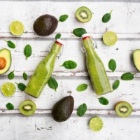 two bottles of green smoothie with avocado, spinach, kiwi and lime - junk food stock pictures, royalty-free photos & images