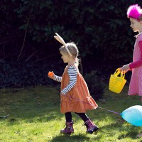two children on easter egg hunt - garden decoration stock pictures, royalty-free photos & images