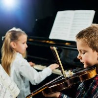 two children playing musical instruments. - concert stock pictures, royalty-free photos & images
