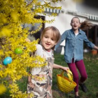 two children running in a back yard searching for easter eggs - garden decoration stock pictures, royalty-free photos & images
