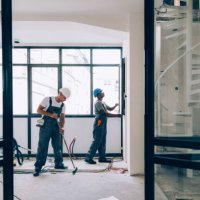two construction workers working together on an apartment renovation - home decoration stock pictures, royalty-free photos & images