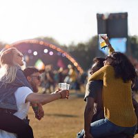 two couples piggybacking at big festival outside - concert stock pictures, royalty-free photos & images