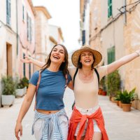 two female friends having fun on the street in alcúdia in mallorca in spain - travel stock pictures, royalty-free photos & images