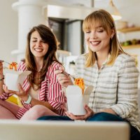 two female friends ordered pasta to eat at home - junk food stock pictures, royalty-free photos & images