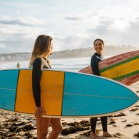 two female friends with surfboards - travel stock pictures, royalty-free photos & images