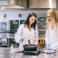 two female scientist cooking genetic meat - food stock pictures, royalty-free photos & images