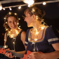 two friends enjoying night out at rooftop party - concert stock pictures, royalty-free photos & images