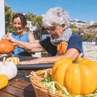 two ladies sitting in the garden and creating halloween decoration - garden decoration stock pictures, royalty-free photos & images