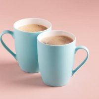two light blue mugs with coffee stand on a powdery background,horizontal orientation,romania - coffee stock pictures, royalty-free photos & images