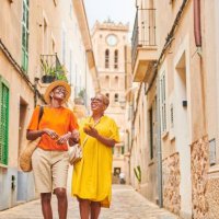 two mature women walking together exploring an old town in europe. - travel stock pictures, royalty-free photos & images