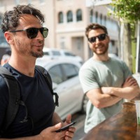 two men ordering food at market stall in the city - junk food stock pictures, royalty-free photos & images