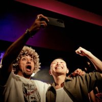 two men taking selfies with their cell phones at a live music club. - concert stock pictures, royalty-free photos & images