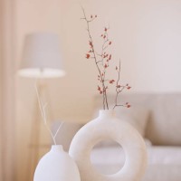 two modern white vases with brunches. white 3d rendering objects with blured interior background. minimalism japandi or scandinavian boho style - home decoration stock pictures, royalty-free photos & images