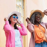 two multiracial senior women in sunglasses and sun hats - fashion stock pictures, royalty-free photos & images