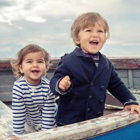 two smiling children playing in a worn rowboat - fashion stock pictures, royalty-free photos & images