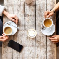 two woman friends meeting at a coffee shop - coffee stockfoto's en -beelden
