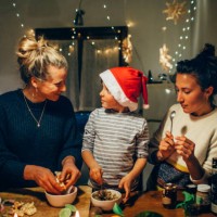two women preparing christmas dinner with young boy - food stock pictures, royalty-free photos & images