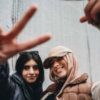 two young adult girls are making funny gestures to the camera - fashion stock pictures, royalty-free photos & images