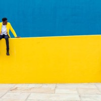 two young african friends keeping social distance over yellow and blue background. friendship and social relationship concept. copy space for text. banner template - fashion stock pictures, royalty-free photos & images