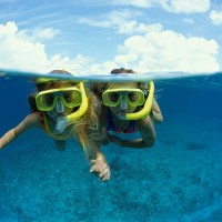 two young girls snorkeling (cayman) - travel stock pictures, royalty-free photos & images