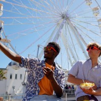 two young male adults taking having fun at the seaside - taking a selfie - junk food stock pictures, royalty-free photos & images