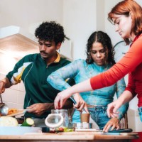 two young woman and young men preparing fresh food for take away - junk food stock pictures, royalty-free photos & images