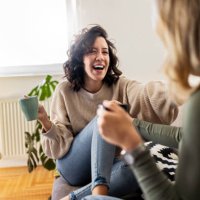 two young women having coffee and chatting having great time - coffee stock pictures, royalty-free photos & images