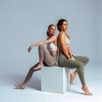 two young women relaxing after fitness training session - fashion stock pictures, royalty-free photos & images