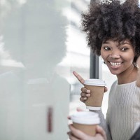 two young women with coffee looking through shop window - junk food stock pictures, royalty-free photos & images