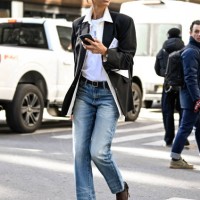 TyLynn Nguyen is seen wearing a black blazer, white shirt, blue jeans, black heels and black sunglasses outside the Calvin Klein show during NYFW F/W...