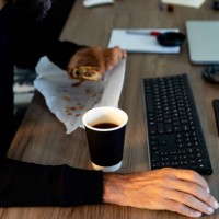 unhealthy eating in the office - junk food stock pictures, royalty-free photos & images