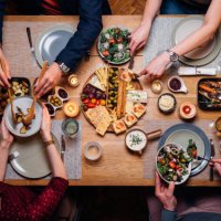 unrecognizable friends and family sharing food at dinning room - food stock pictures, royalty-free photos & images