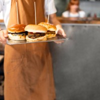 unrecognizable male teenager holding tray with burgers, at the fast food restaurant - junk food stock pictures, royalty-free photos & images