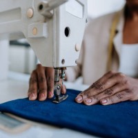 unrecognizable person sewing using sewing machine - fashion stock pictures, royalty-free photos & images