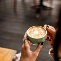 unrecognizable woman having a cup of coffee - coffee stockfoto's en -beelden
