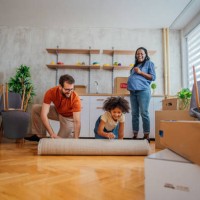 unrolling carpet in a new house - home decoration stock pictures, royalty-free photos & images
