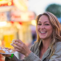 usa, maine, rockland, woman eating funnel cake at funfair - food stock pictures, royalty-free photos & images