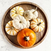 variety of pumpkins on a wooden tray on white, marble background - home decoration stock pictures, royalty-free photos & images