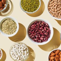 various kinds of vegan protein sources on beige background. set of food supplements. gluten free cereals as ground hemp seeds, quinoa. nuts and legumes (green mung beans, chick-pea, red lentil, kidney bean, almonds, hazelnuts