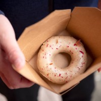 vegan gourmet donut with rose petals in cardboard container - junk food stock pictures, royalty-free photos & images