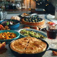 vegan thanksgiving dinner with pumpkin & kale pot pie, butternut squash, roasted green beans with almond bacon, radicchio clementine salad and berry pie - food stock pictures, royalty-free photos & images