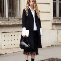 Veronika Heilbrunner wears white shirt, black fish net skirt, black coat, black socks, black loafer and black Dior bag outside the Dior show during...