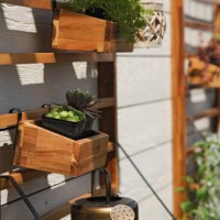 vertical garden of wooden furniture with watering cans and plants - garden decoration stock pictures, royalty-free photos & images