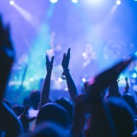 vertical photo of an unrecognizable person clapping hands at a music concert - concert stock pictures, royalty-free photos & images