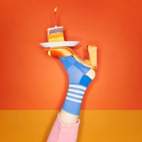vibrant foot balancing slice of birthday cake - food stock pictures, royalty-free photos & images